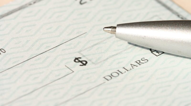 person filling out a personal check