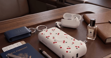 Essential travel gadgets including a portable charger, power bank, phone and travel accessories