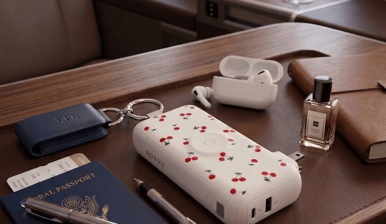 Essential travel gadgets including a portable charger, power bank, phone and travel accessories